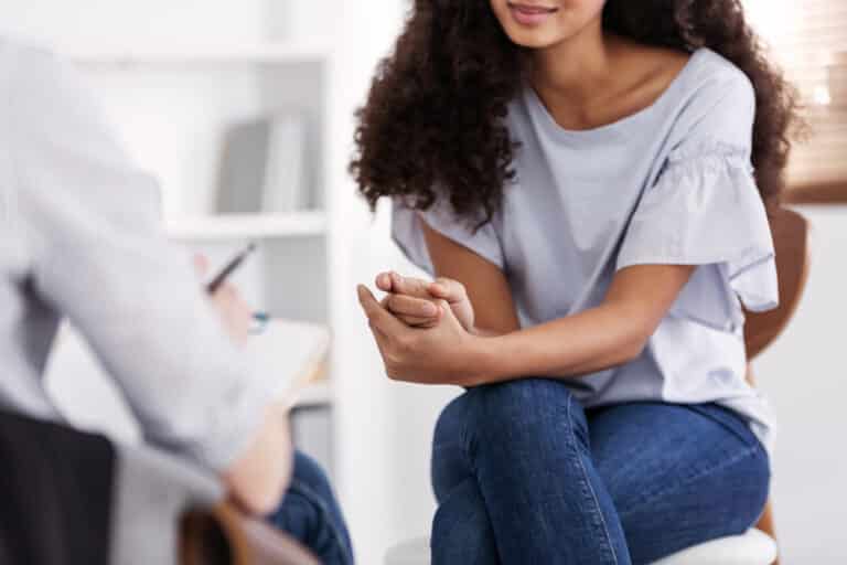 Young woman talking to therapist in office